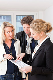 Realtor explaining paperwork to a couple